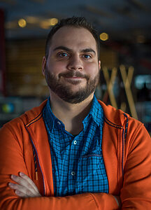 Portrait of Veselin Panayotov, Bulgarian animator and freelance artist, standing with arms crossed and smiling.